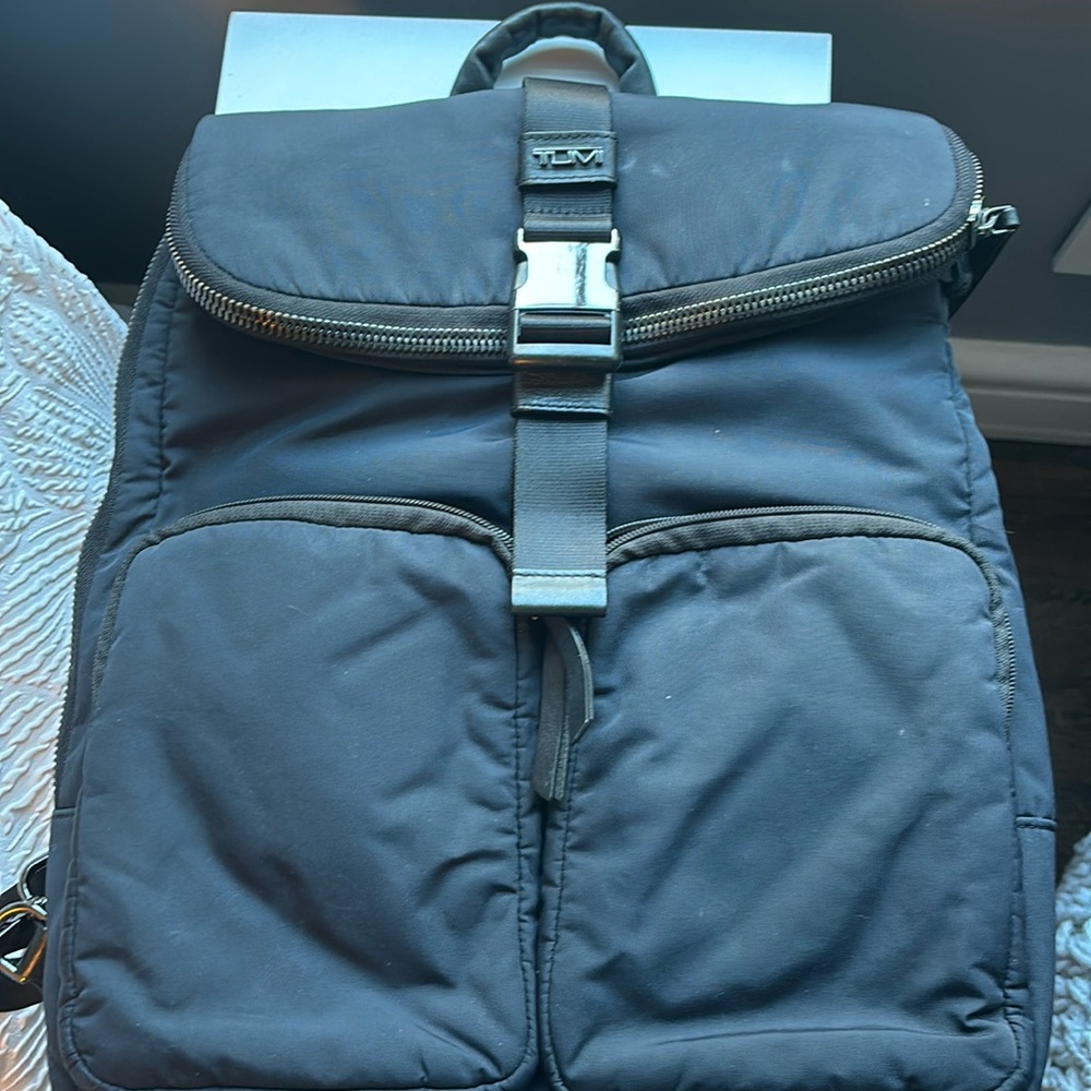 Tumi backpack that fits on your carryon handle.  Tons of pockets and secure !